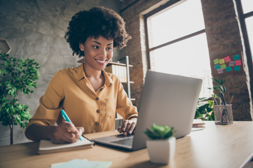 woman on computer taking notes